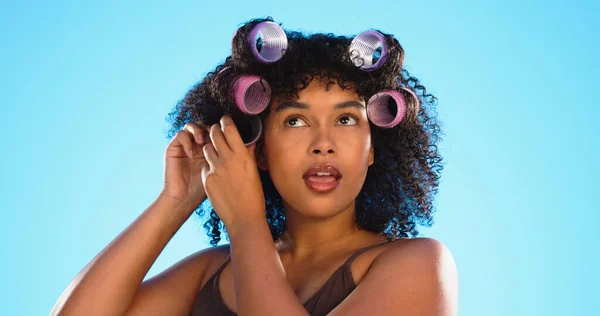 Black woman, hairstyle curlers and studio background with smile for beauty, self care and natural aesthetic. Happy gen z model, african girl and natural hair with happiness, plastic mould and soft.