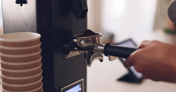 stock image Coffee machine, barista hand and grind beans in cafe, closeup and prepare latte or espresso drink with service. Hot beverage, person working in restaurant and brewing process, premium blend caffeine.