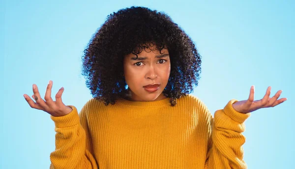 stock image Face, confused and unsure black woman in studio, pensive and dont know gesture on blue background. Doubt, portrait and girl with decision, why or emoji on mockup, product placement or isolated.