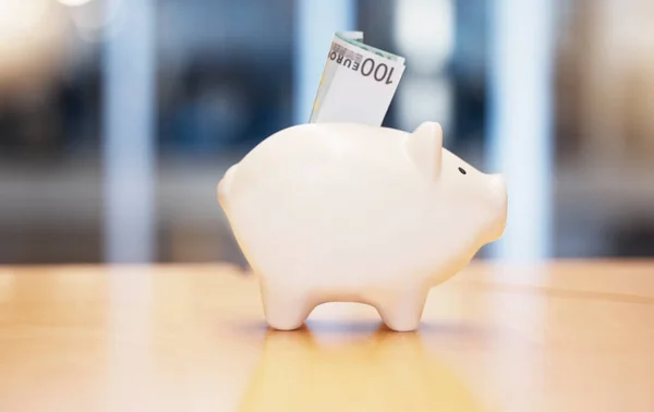 stock image Saving, money and piggybank on a table for finance, budget and investment. Security, dollar and a tool for savings, cash safety and financial growth at a company for banking and pension wealth.