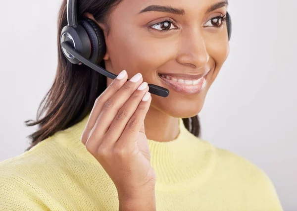 Woman is happy, face with callcenter and headset with mic, CRM and contact us with consultant on studio background. Indian female smile with customer service agent and help desk with tech support.