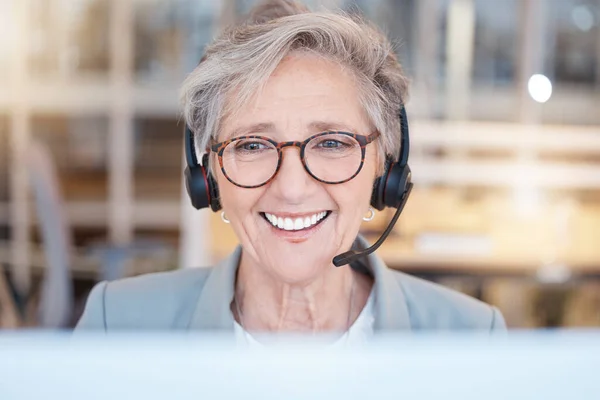 stock image Telemarketing, consultant and senior woman with smile, customer service and call center in workplace. Mature female employee, entrepreneur and agent with headset, happiness and tech support in office.