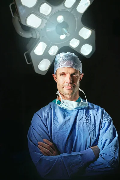 He takes your health seriously. Cropped portrait of a male doctor against a dark background