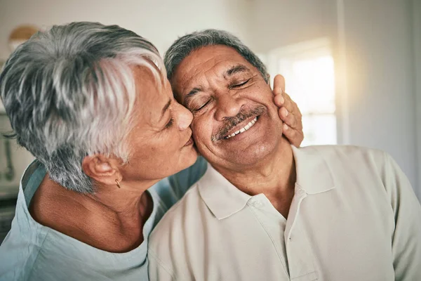 Love, kiss and elderly face of happy couple romance, spouse support and smile during retirement time together. Happiness, romantic marriage partner and senior woman, old man or people bonding at home.
