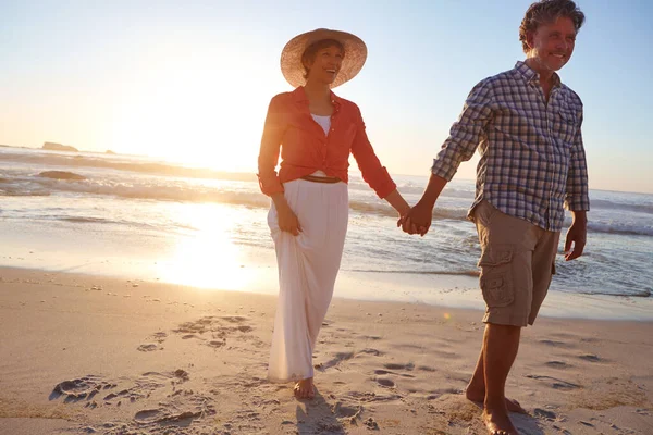 日没と愛が一緒に行く 成熟した夫婦は午後遅くにビーチを散歩し — ストック写真