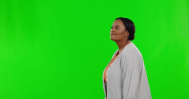 看起来和一个黑人女人走在一个绿色的屏幕上隔离在工作室的背景 印象深刻 一位非洲女士在一个背景下 反应和羡慕铬色的模拟空间 — 图库视频影像