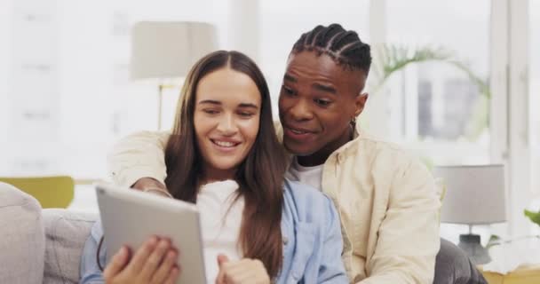 タブレット 笑顔とカップルはソファの上の自宅のリビングルームでリラックスし オンラインショッピングと話しています ソーシャルメディアやインターネットの閲覧のためのタッチスクリーンを持つ異人種間 技術と幸せな黒人男性と女性 — ストック動画
