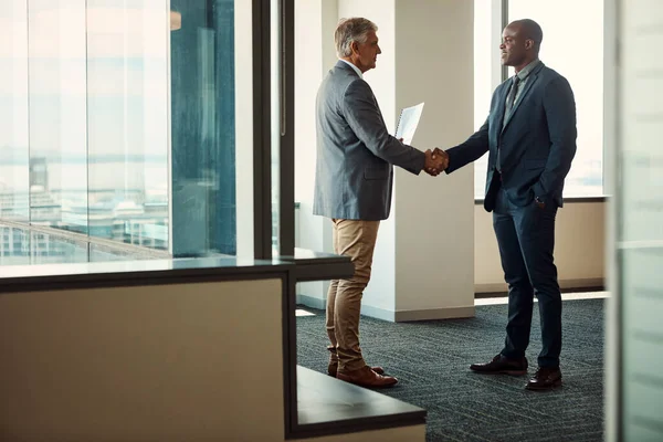 stock image Grow your network, grow your success. Full lengths shot of two businessmen shaking hands in an office