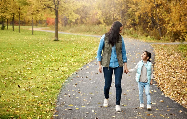 Mommy and me. a mother and her little daughter enjoying a walk outdoors