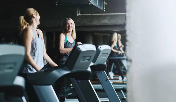 stock image Catching up while jogging. mature women working out in the gym