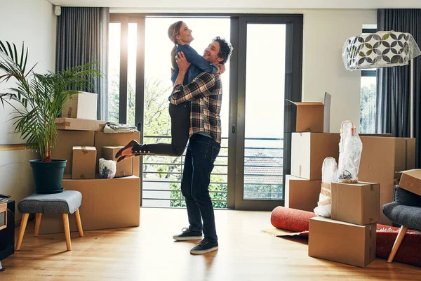 stock image At last we can call this home. a cheerful middle aged couple holding each other in excitement after moving into their new home inside during the day