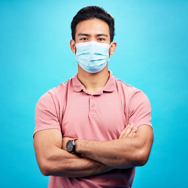 戴口罩的男人 手臂交叉在肖像和眼镜蛇中 免受病毒 细菌和蓝色背景细菌的侵害 电晕和男性患者 遵守工作室保护规定的情况 — 图库照片
