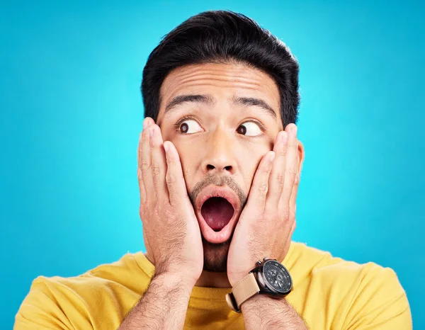stock image Surprised, announcement and shocked face of a man or emoji reaction to a deal isolated in a blue studio background. OMG, fake news and male model with amazed facial expression in backdrop.