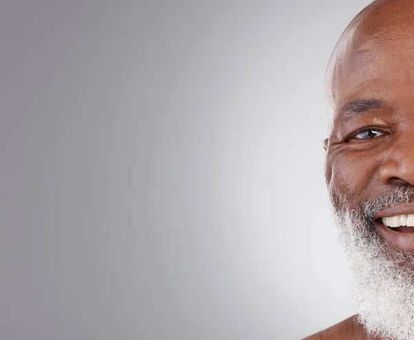 stock image Senior black man, face and smile on mockup for skincare, hygiene or grooming against a gray studio background. Portrait of happy African elderly male smiling for self love or skin care on copy space.