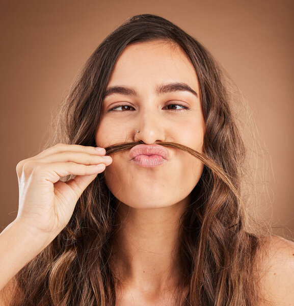 Hair care, comic mustache and face of woman for wellness, hairstyle and health on studio background. Salon aesthetic, hairdresser and silly girl with cosmetics, keratin treatment and natural beauty.