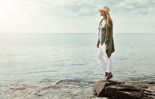 stock image The perfect place to go with the flow. a young woman spending a day at the lake