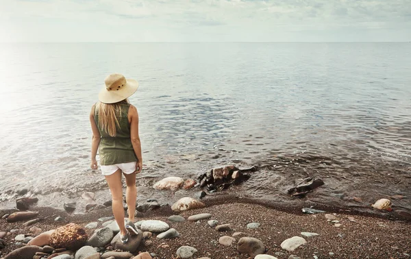 stock image Close to nature is where I need to be. Rear view shot of an attractive young woman spending a day at the lake