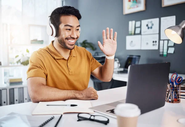 Man, headphones and laptop, video call with smile and wave hello, remote work with workshop webinar. Communication, working from home and virtual meeting seminar, happy male freelancer and internet.