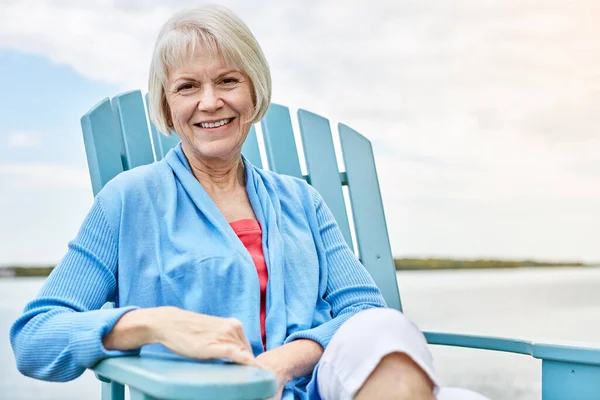 stock image Having the rest of my life. Portrait of a happy senior woman relaxing on a chair outside