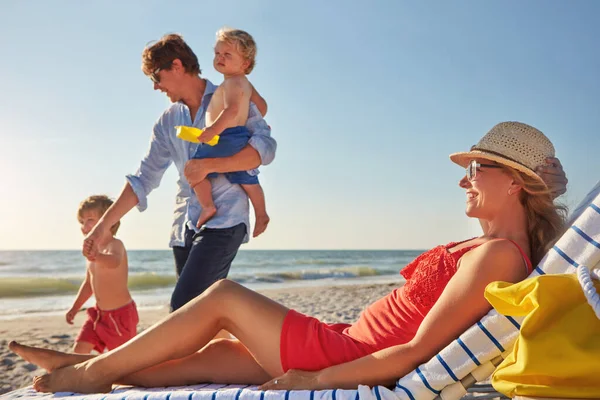 stock image Mom deserves her break. a family spending the day at the beach together