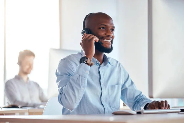 Call center, computer and listening with black man in office for customer service, technical support and advice. Technology, contact us and communication with employee operator in help desk agency.