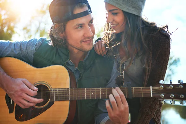 stock image Your love is like music to my ears. a young man playing his girlfriend a song on his guitar