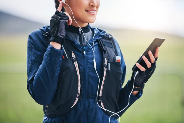 Music, phone hands and woman in the countryside ready for fitness and exercise with mockup. Sports, run training and mobile headphones of a female athlete with audio and web radio for workout.