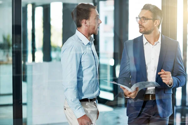 stock image You have some great ideas. two businessmen talking over some paperwork in an office