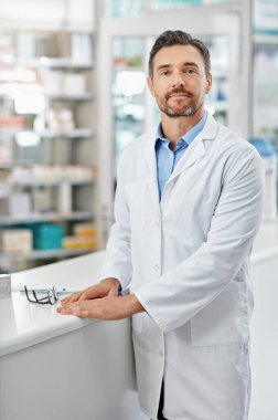 Get your medicine supplied without going to the GP. Portrait of a pharmacist standing in a drugstore. All products have been altered to be void of copyright infringements clipart