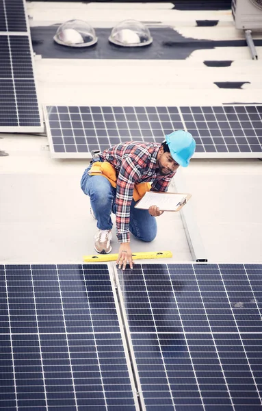 Black man with clipboard, solar panels inspection and renewable energy, sustainable and eco friendly technology. Maintenance check, male engineer and infrastructure with electricity and top view.