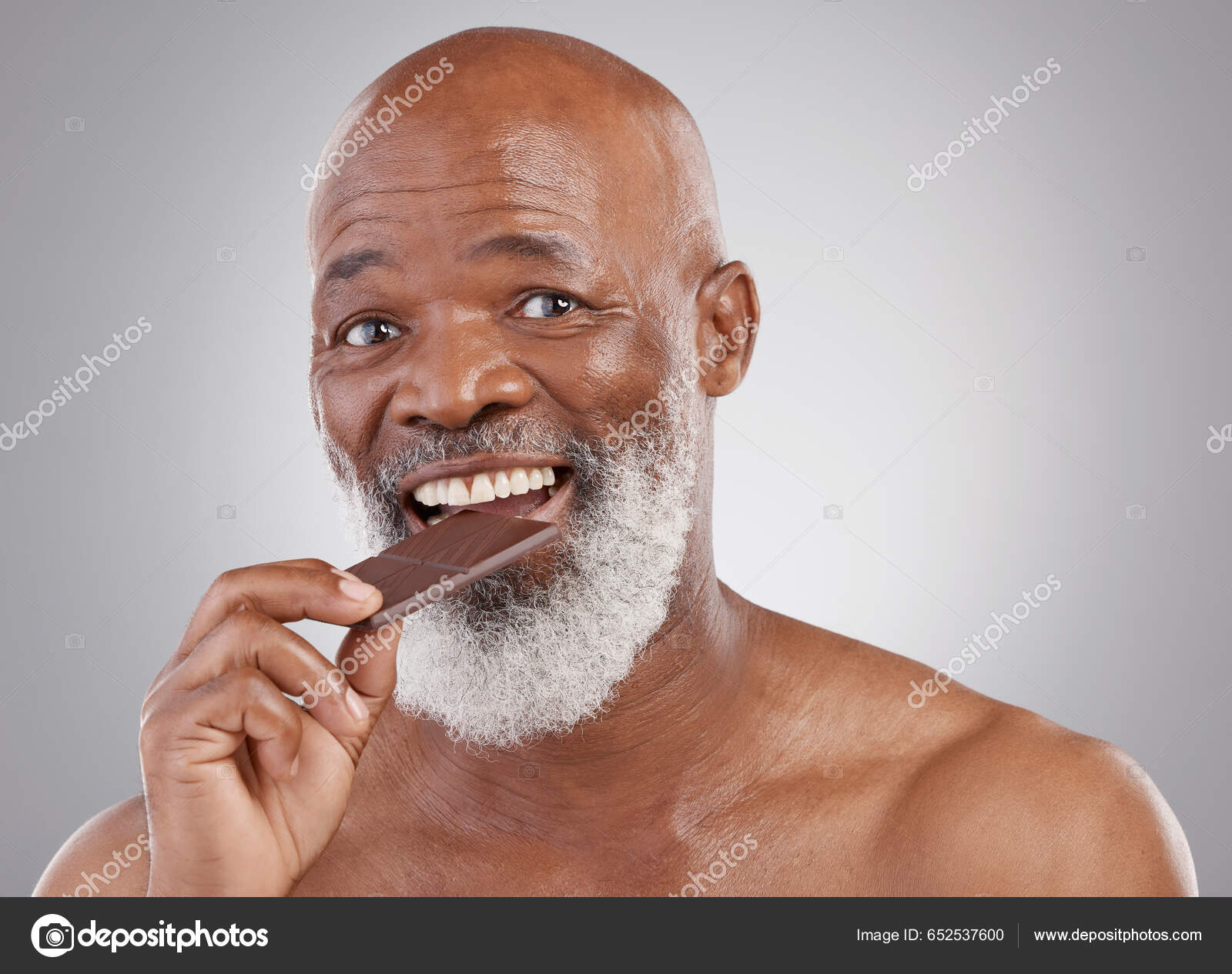 Black Man Portrait Eating Chocolate Sweets Isolated Studio Background Treat  — Stock Photo © PeopleImages.com #652537600