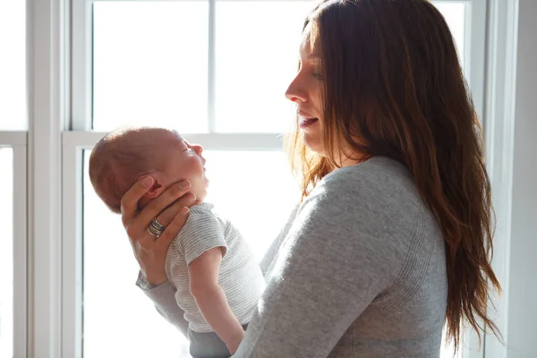 Stock image Hes just too adorable. a mother holding her newborn baby