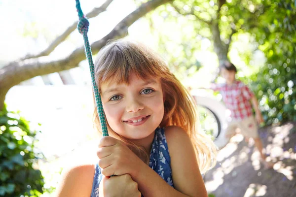 子供の頃のシンプルな喜び 庭で揺れる少女 — ストック写真