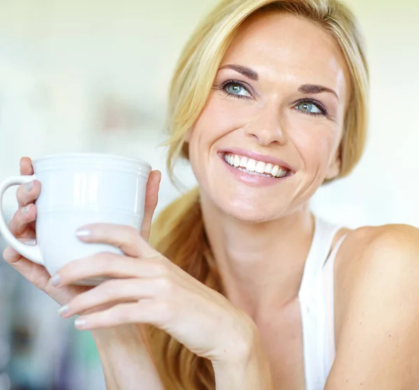 Stock image Great coffee and a brilliant smile. Attractive young blonde woman enjoying a delicious freshly-brewed cup of coffee