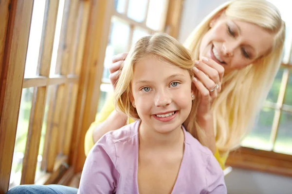 stock image Getting mom to do my hair. Portait of a loving mother and daughter spending time together at home