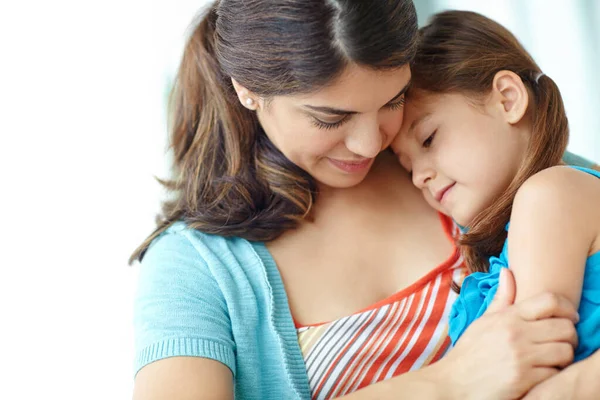 stock image Nothing like a mothers love. A young mother hugging her cute daughter affectionately