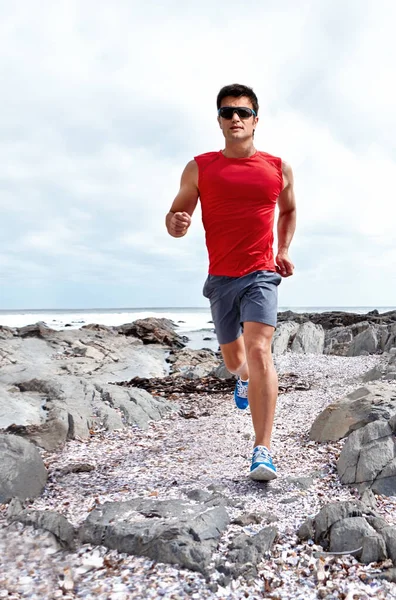 stock image Nothing beats an early morning jog. A young athlete running outdoors