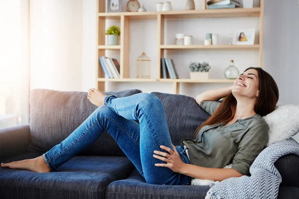 stock image Nothing beats getting to lay back after a long week. a beautiful young woman relaxing in the sofa at home