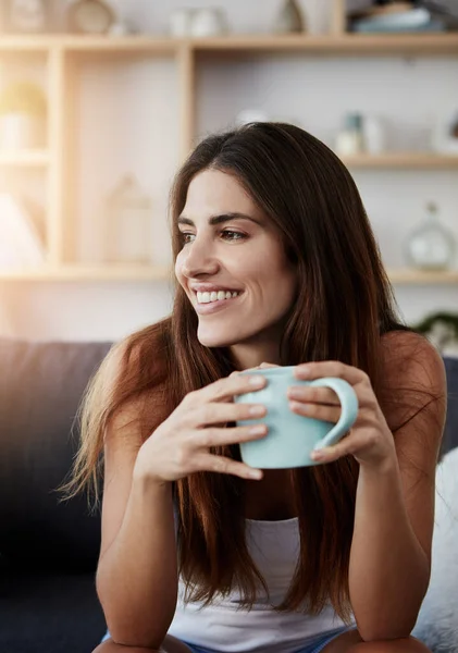stock image Coffee and some morning positivity. a young woman enjoying a cup of coffee while relaxing in the lounge