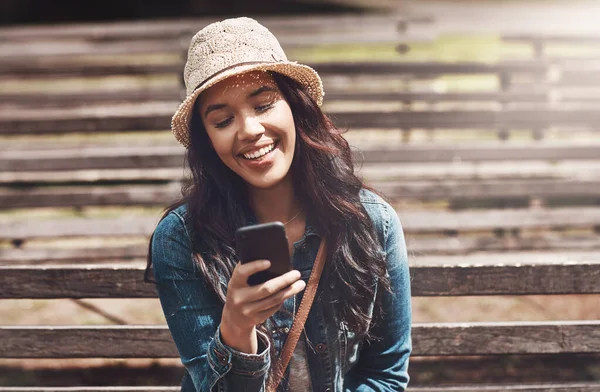 stock image All her texts end with a smiley. an attractive young woman using a cellphone at the park