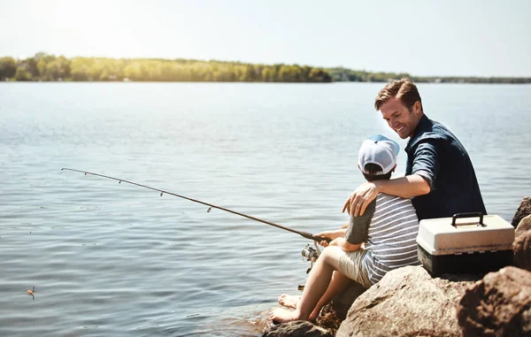 stock image Youre already becoming an expert at this. a father and his little son fishing together