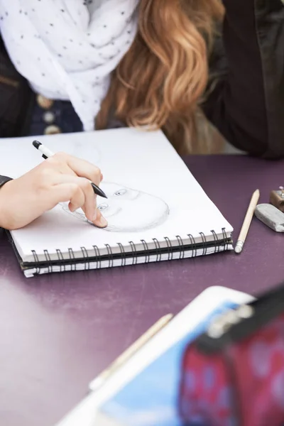 stock image Drawing, design and a woman with a notebook for school creativity, exam sketch and inspiration. College, art and a student writing or doing a doodle on paper for education and university class.