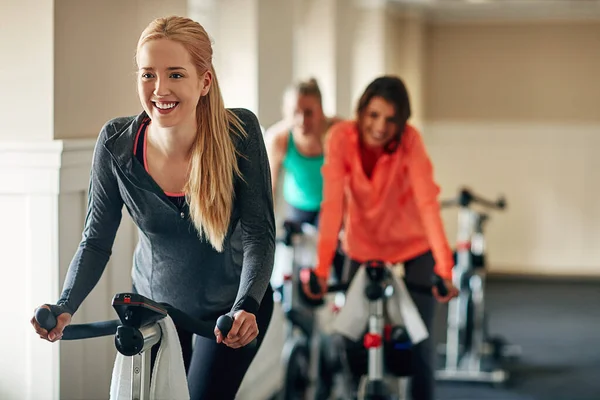 Nothing beats a workout on a bike. a young woman working out with an exercise bike in a spinning class at the gym