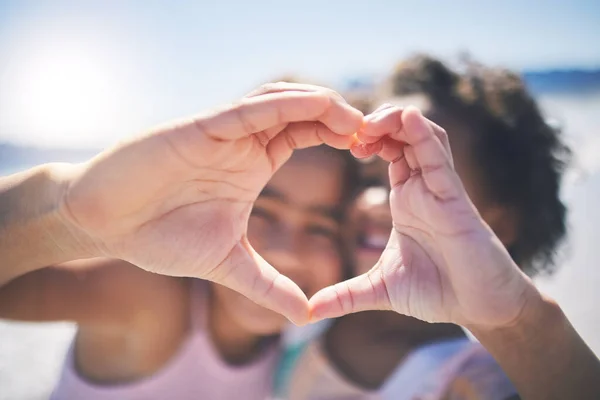 Happy, outdoor and girls with heart hands, support and wellness on break, relax or bonding. Friends, young people or children with happiness, symbol for love or emoji with care, solidarity or outside.