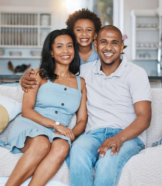 stock image Happy, black family and portrait of parents with son on sofa for bonding, quality time and relaxing at home. Love, living room and mother, father and child on couch with smile, hugging and happiness.