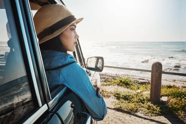 stock image Who knows what the next road will lead her to. a young woman enjoying a road trip along the coast