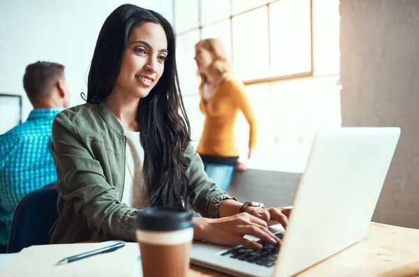 stock image If you can dream it, she can design it. an attractive young businesswoman working in a modern office with her colleagues in the background