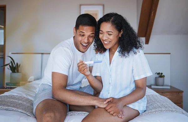 Pregnant, test and excited couple on bed with positive results, good news and celebration at home. Pregnancy, maternity and happy man and woman in bedroom for fertility, future family and surprise.
