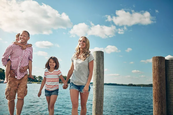 stock image The bond of love and creation. a young family on a pier while out by the lake