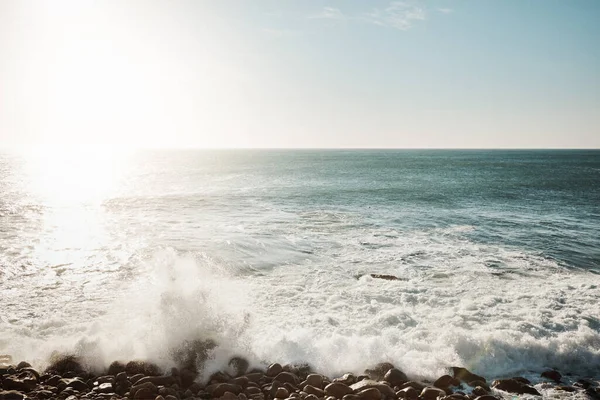 stock image Nature shore is beautiful. water crashing against some boulders at the beach